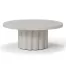 A white circular coffee table with a scalloped column base.